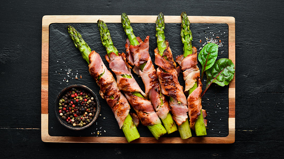 Asparagus baked with bacon and spices. Healthy food. Top view. Free space for your text.