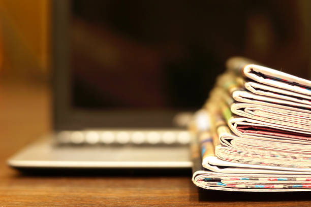 istock Newspapers and Laptop 1151320872