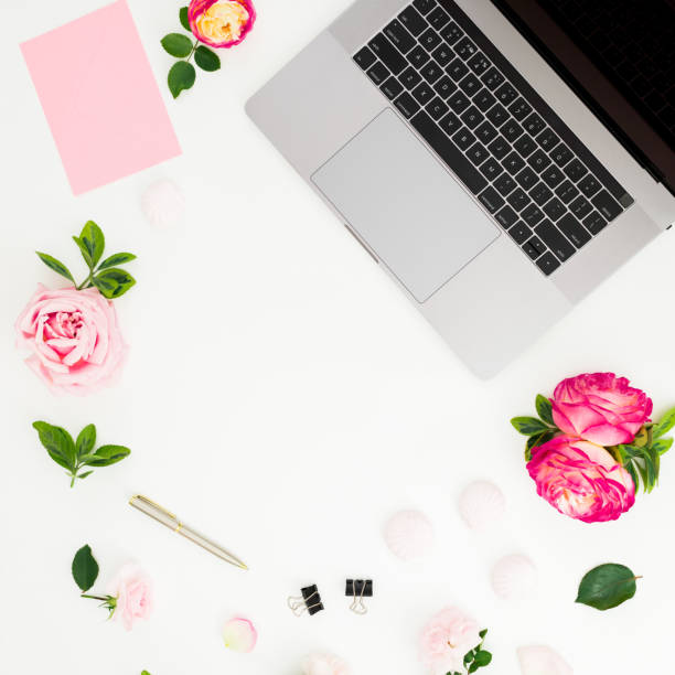 istock Laptop, roses flowers, diary, pen, envelope and marshmallow on white background. Flat lay. Top view. Business composition with copy place 1151321047