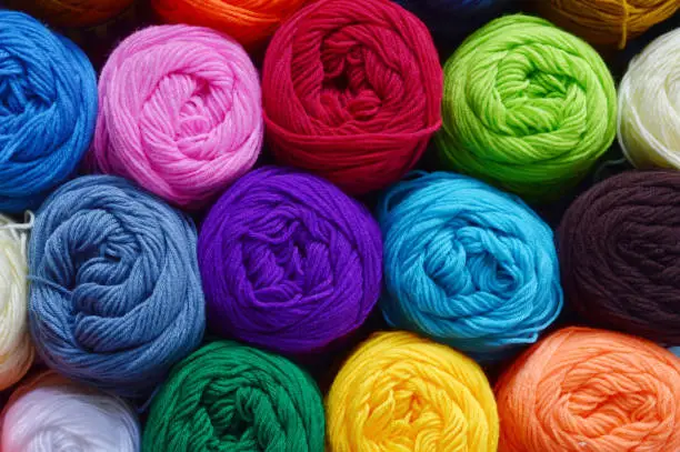 Blurry background of colorful knitting. View from above of colorful knitting.