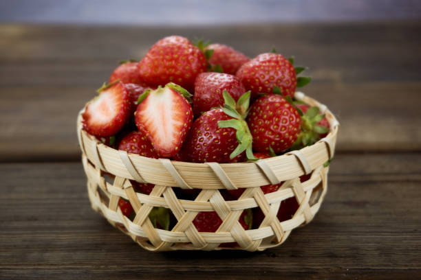 istock Strawberries close up on wood background. 1151322122
