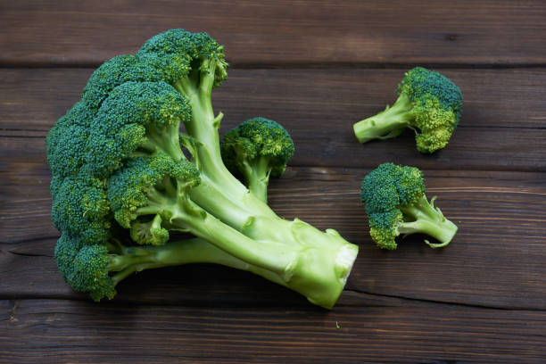 istock Ripe Broccoli Cabbage Isolated on Wood Background 1151322269