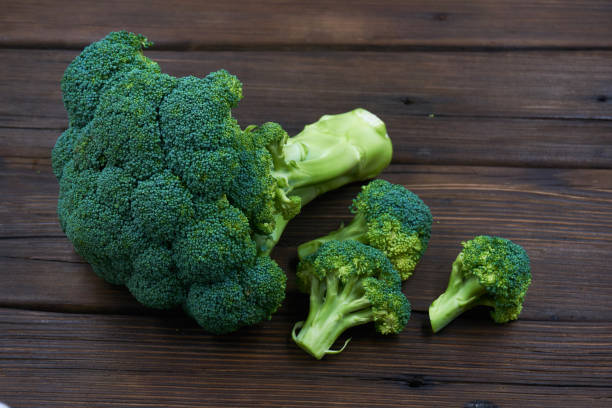 istock Ripe Broccoli Cabbage Isolated on Wood Background 1151322282