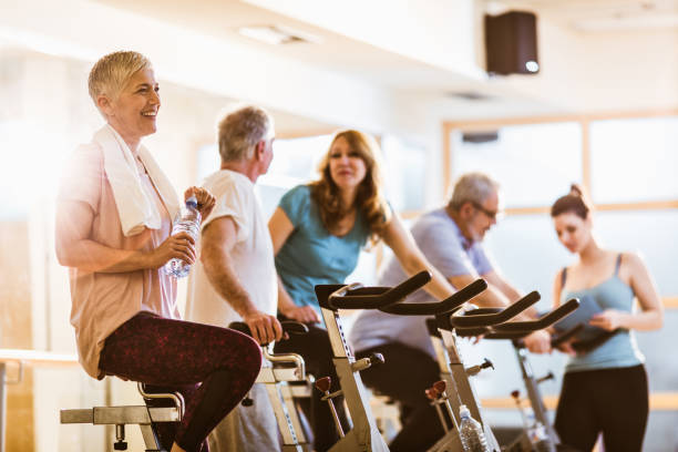 istock Active senior woman having water break while being on exercising class in a gym. 1151326762