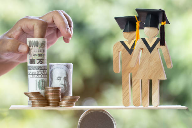 istock University Education learning abroad international Idea. Student Graduation save coins US dollar,JPY on wood round box balance. Concept of study requires money cost saving for success. Back to School 1151327427