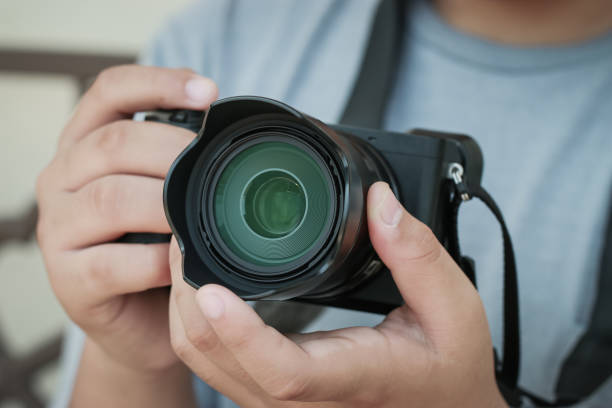 istock Professional photographer working mirrorless camera before shooting or take photo, lens focus. Hobby creative equipment photography taking concept 1151327956