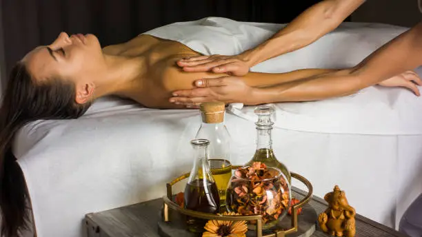 Photo of Masseur makes massage to girl oil.