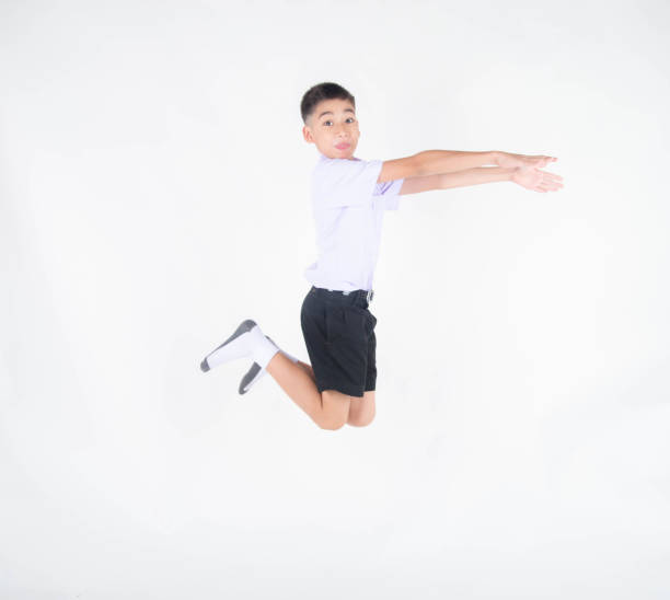 istock Little Asian boy in student uniform on white background 1151331355