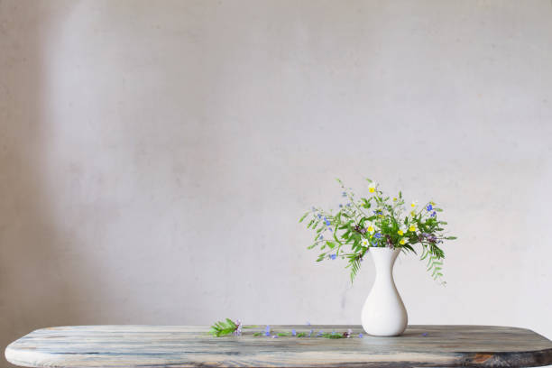 istock wildflowers in white vase on background old wall 1151335898