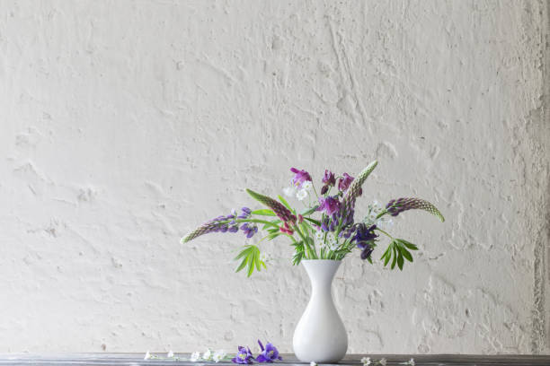 istock summer flowers in vase on background white wall 1151336339