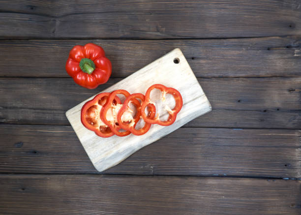 istock Fresh juicy peppers isolated on a wood background. 1151336794