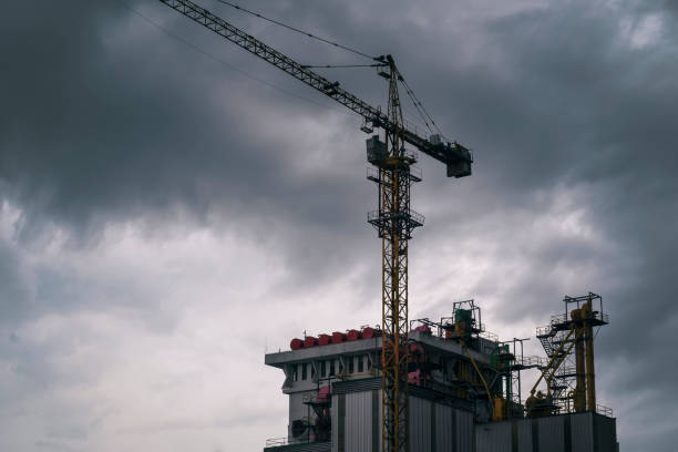 Silhouette of the construction site on sunset background