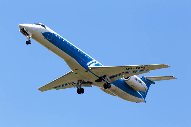 UR-DPB Wind Rose Aviation Embraer ERJ-145 aircraft on the blue sky background stock photo