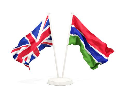 Two waving flags of United Kingdom and gambia isolated on white. 3D illustration