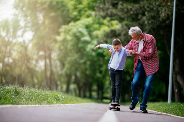 istock Grandfather and grandson having fun, skateboarding 1151341896