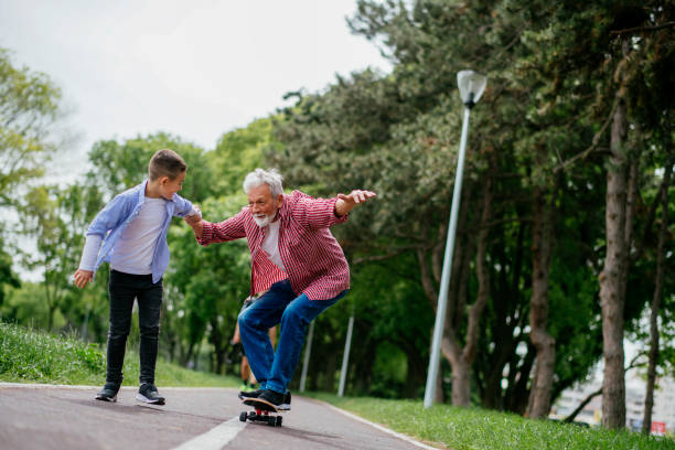 istock Grandfather and grandson having fun, skateboarding 1151342068