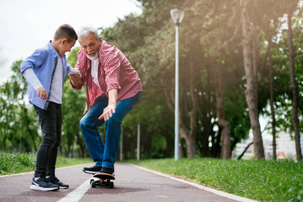 istock Grandfather and grandson having fun, skateboarding 1151342495