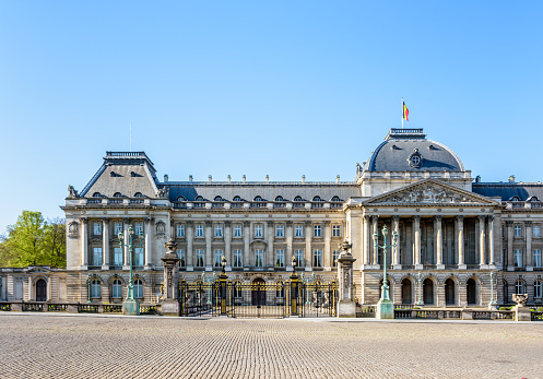Brussels, Belgium - April 20, 2019: Front view of the colonnade and left wing of the Royal Palace of Brussels, the official palace of the King and Queen of the Belgians in the historic center.