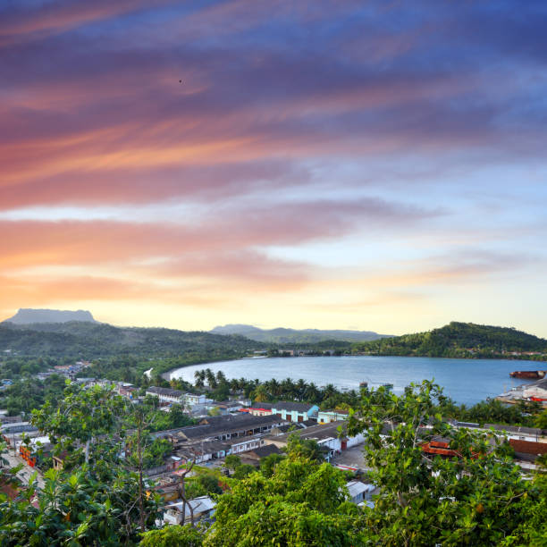 Sunset over Baracoa Bay, Cuba Baracoa was discovered by Christopher Columbus during his first voyage, on 27th November 1492. Composite photo baracoa stock pictures, royalty-free photos & images