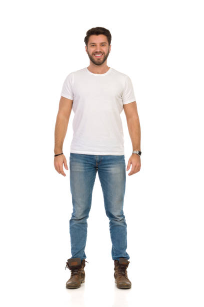 istock Smiling Man In Jeans And White T-shirt Is Standing And Looking At camera. Front View. 1151347305