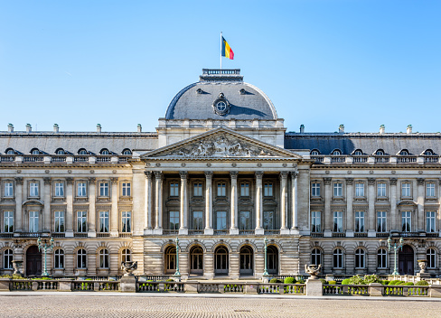 Brussels, Belgium - April 20, 2019: Front view of the colonnade of the Royal Palace of Brussels, the official palace of the King and Queen of the Belgians in the historic center on a sunny morning.