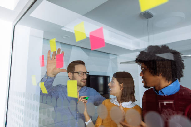 istock Business people brainstorming ideas behind glass wall 1151348015