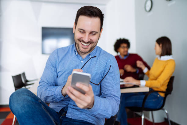 istock Young businessman checking text messages on his smart phone 1151352103