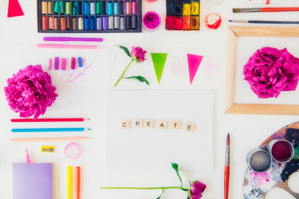 istock Top view creative artist workplace. Blank canvas with Create word lettering, variety of painting supplies and peony flowers. Drawing, inspiration, craft, creativity concept. Art therapy. Flat lay. 1151353347