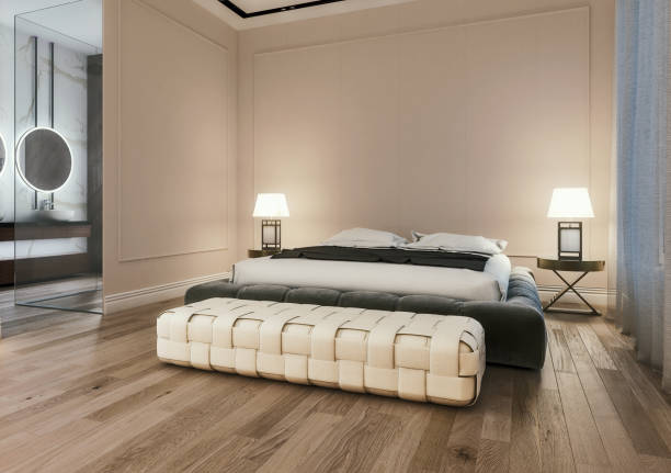 istock Modern interior design of master bedroom with large bathroom, king size bed with bed sheets, wooden flooring and classic style gray walls with decorative moldings, night scene, 3d rendering 1151355698
