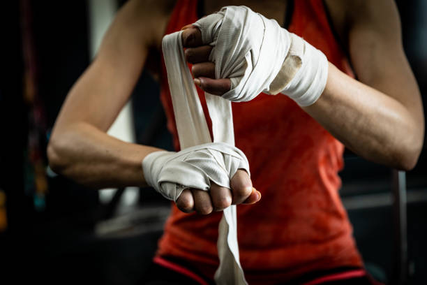 istock Female boxer hand bandaging 1151357903