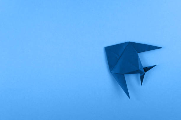 istock Origami tropical fish on sky blue minimalistic background 1151358343