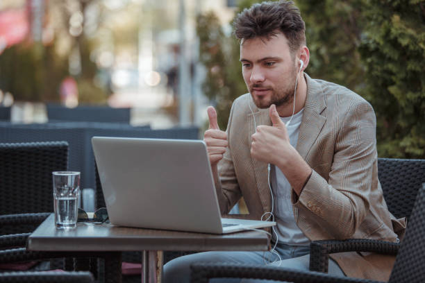 istock Man having online chat in city cafe 1151358473
