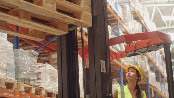 istock Female worker driving on a forklift. Warehouse 1151358946