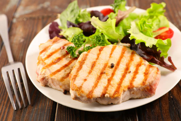 istock grilled pork chop and salad 1151358973