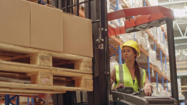 istock Female worker driving on a forklift. Warehouse 1151358980