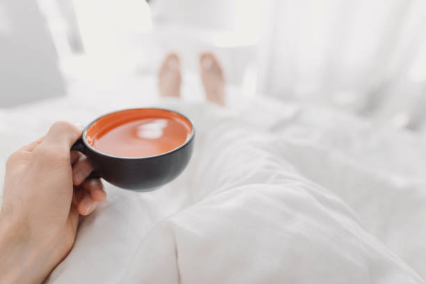 istock POV, drinking morning tea in bed 1151359972