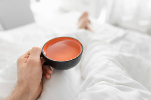 istock POV, drinking morning tea in bed 1151360455