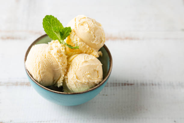 istock Vanilla ice cream balls with mint in a turquoise bowl 1151360592