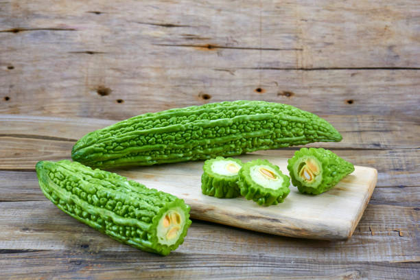 istock Bitter melon , Bitter gourd isolated on wood background. 1151363231