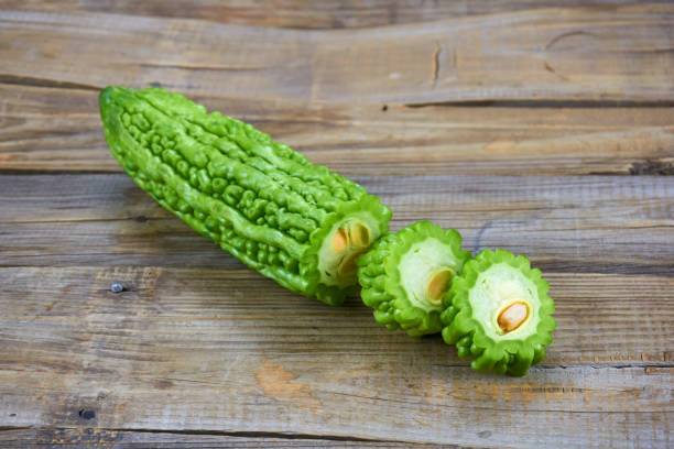 istock Bitter melon , Bitter gourd isolated on wood background. 1151363250