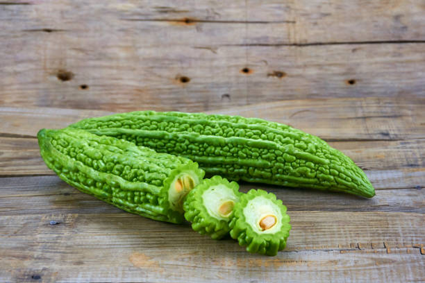 istock Bitter melon , Bitter gourd isolated on wood background. 1151363263