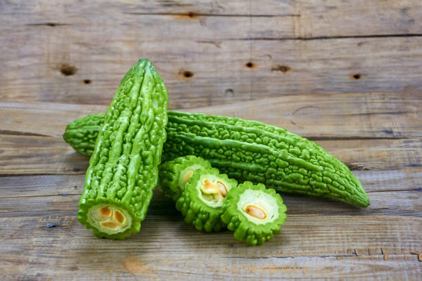 istock Bitter melon , Bitter gourd isolated on wood background. 1151363305