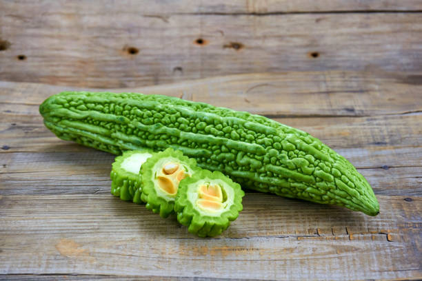 istock Bitter melon , Bitter gourd isolated on wood background. 1151363457