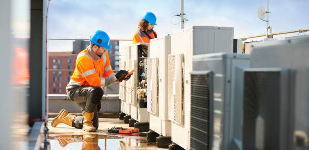 aircon engineers rooftop air con installation reflective clothing photos stock pictures, royalty-free photos & images