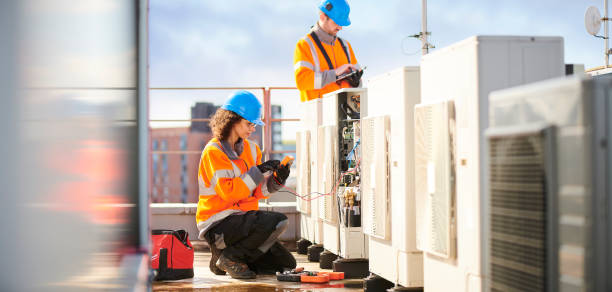 istock female electrician with aircon unit 1151364547