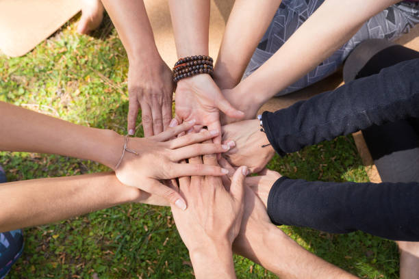 istock Top view of stack of hands against green grass 1151364729