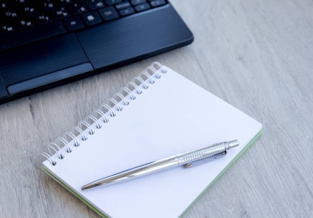 istock Workplace with notepad notebook, Minimal work space - Creative flat lay photo of workspace desk. 1151364791
