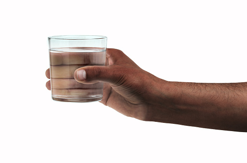 Man hand holding a glass with water isolated on a white background