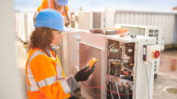 istock female electrician with aircon unit 1151366624