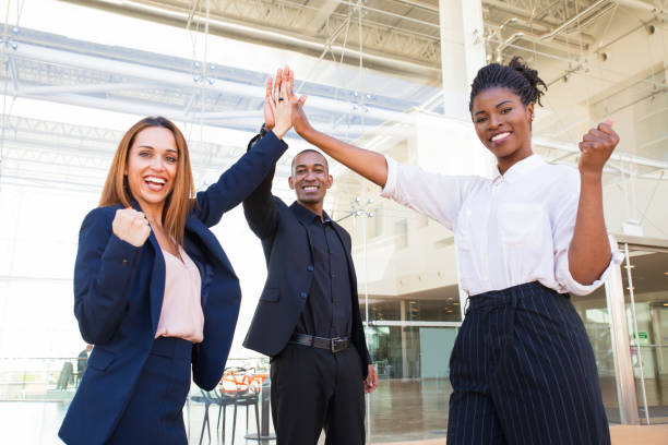 istock Jolly excited interracial colleagues making yes gestures 1151367914